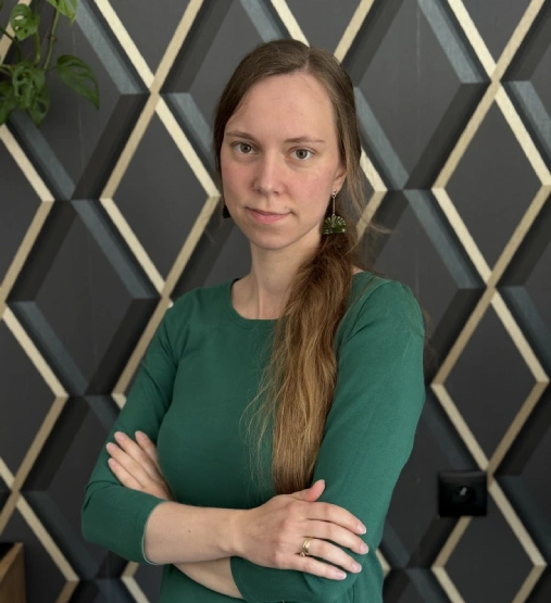 Kobieta z jasnobrązowymi włosami w zielonej sukience. To Joanna Reiter.